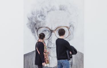couple checking out an old lady painting